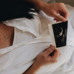 woman holding ultrasound picture