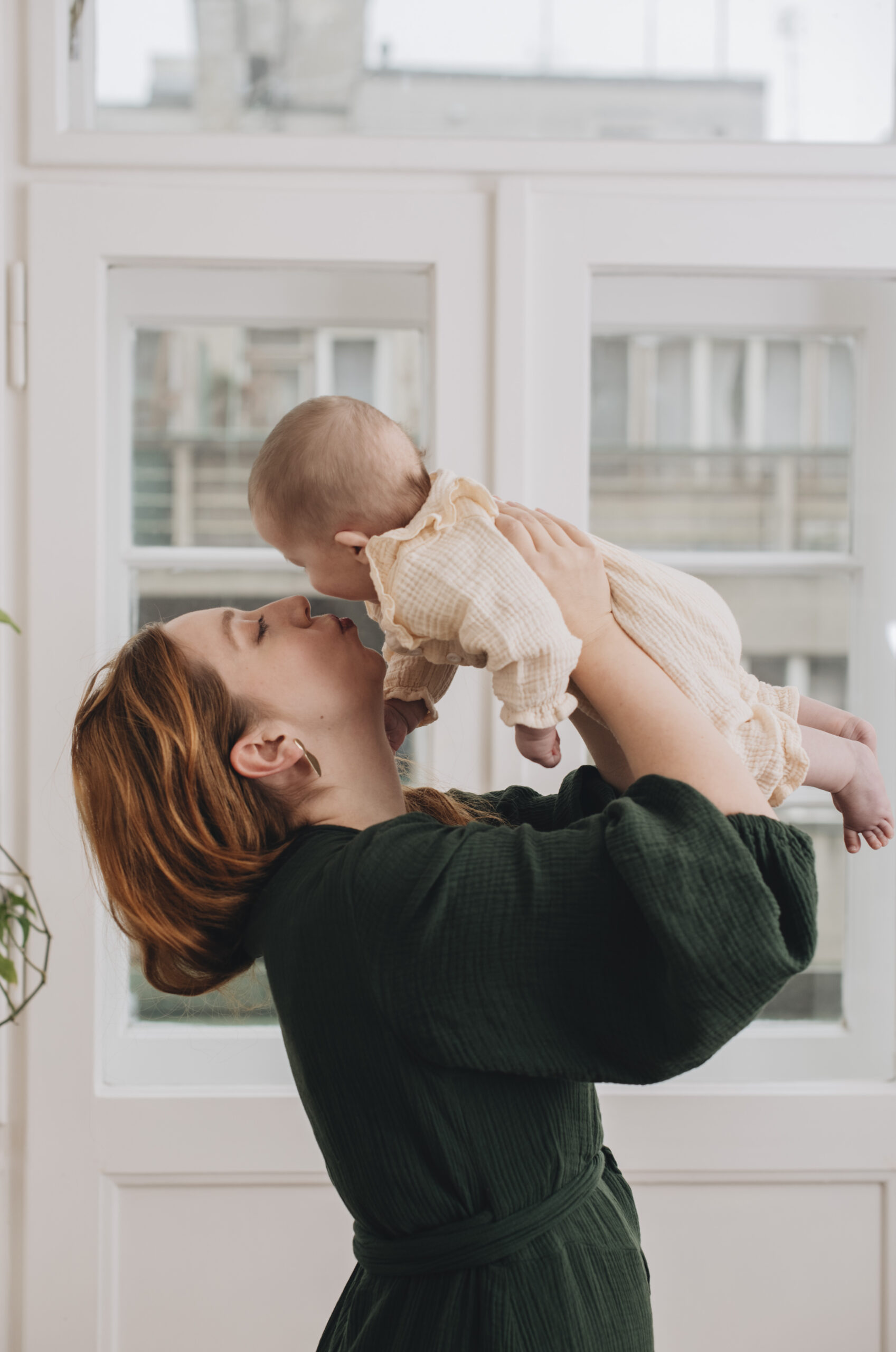 mother holding her baby and kissing