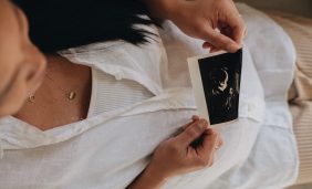 woman holding ultrasound picture